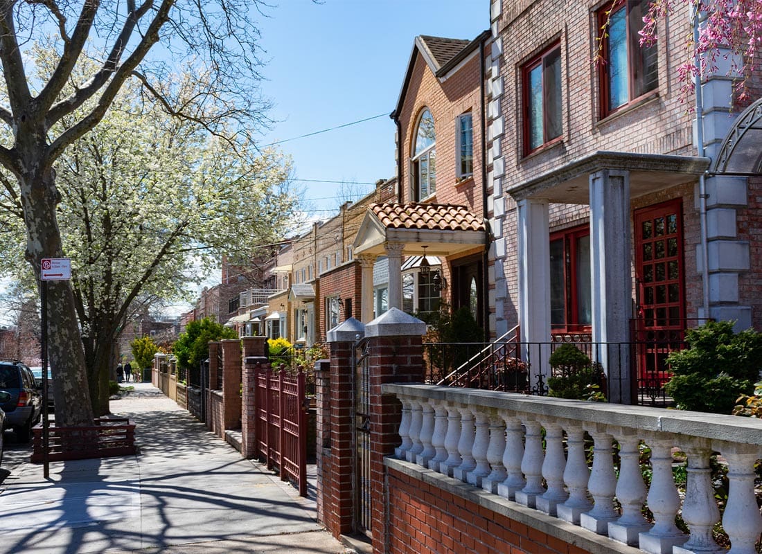 Flushing, NY - Row of Beautiful Homes Along a Sidewalk During Spring in Astoria Queens, New York